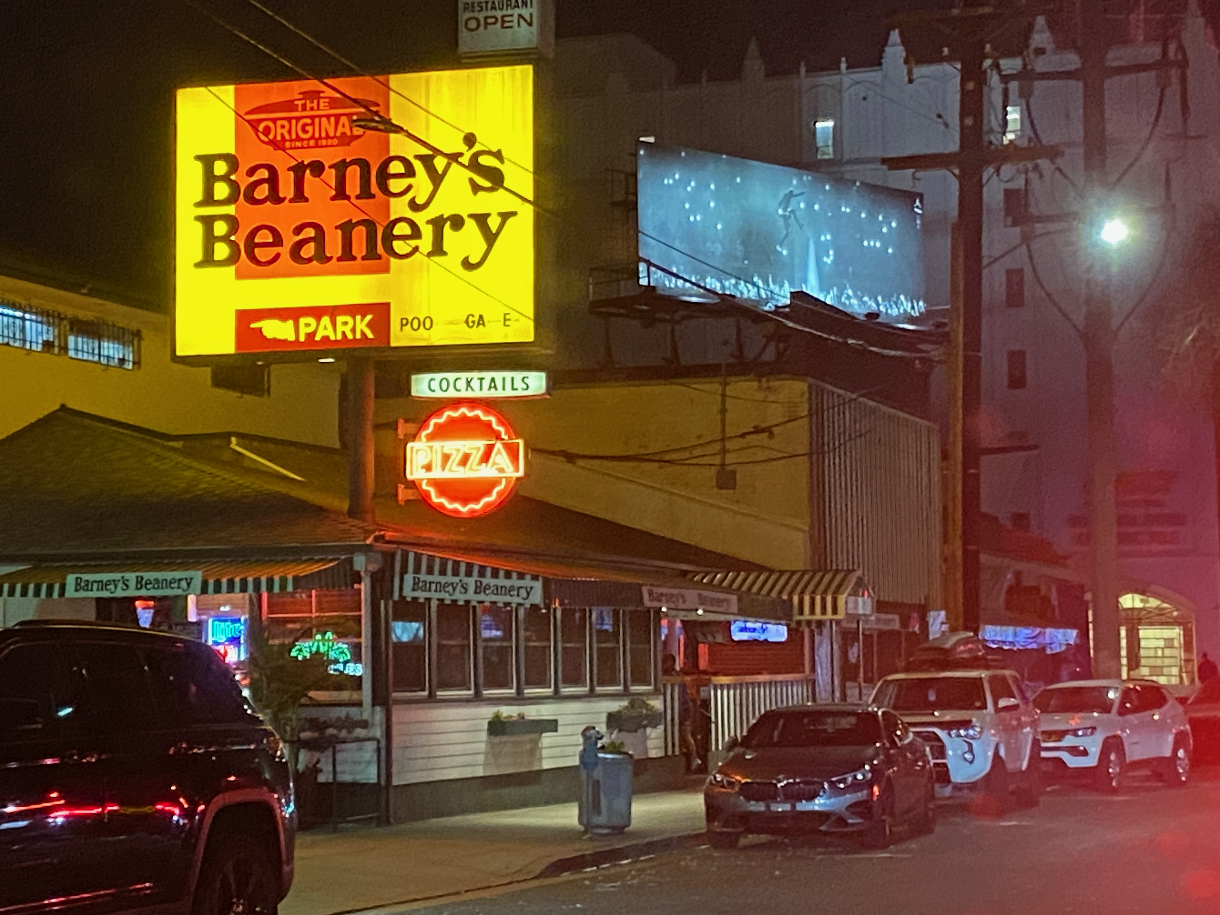 a view of Barney's Beanery in LA, from a car, at night