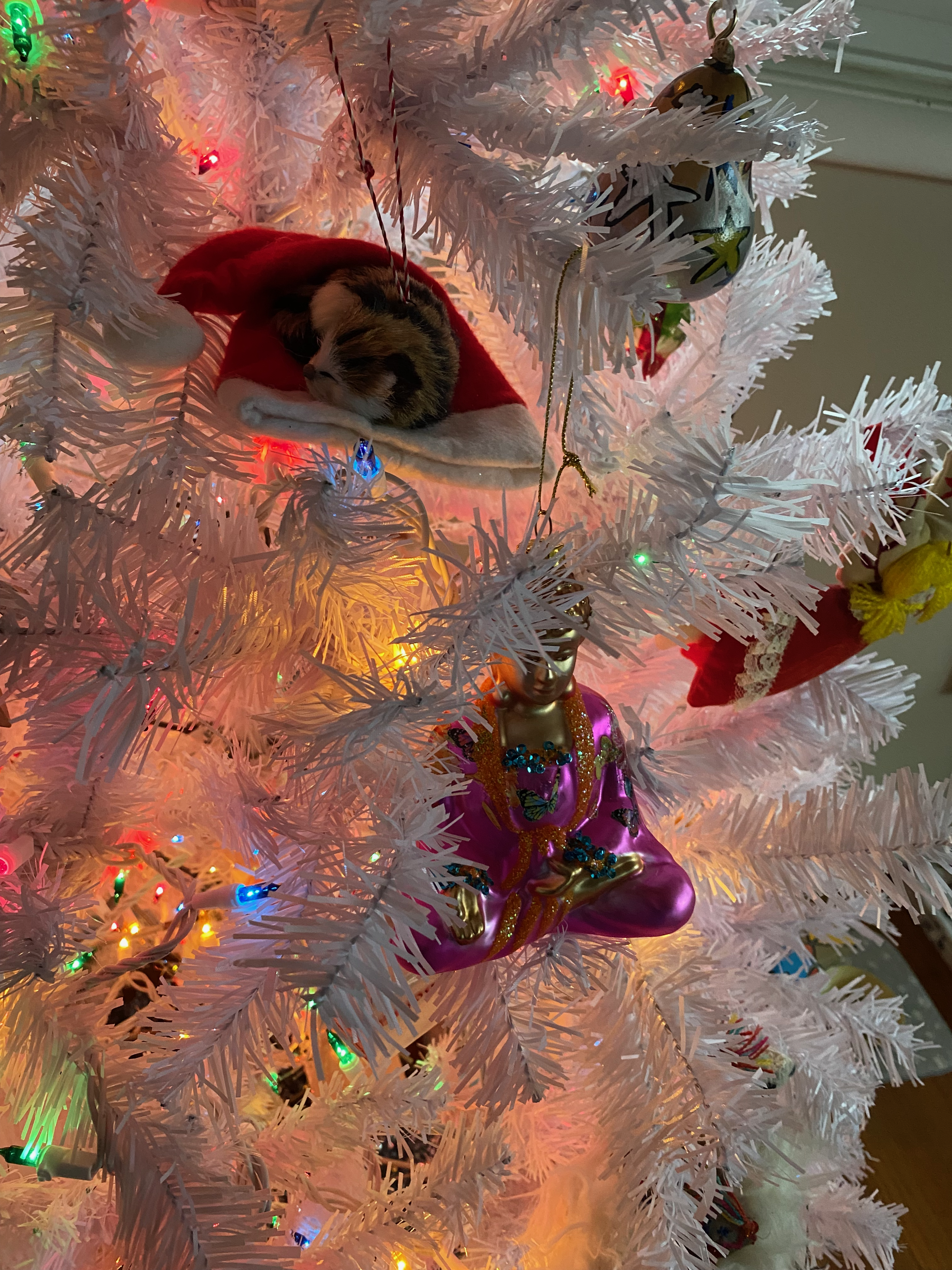 Buddha and cat ornaments on a Christmas tree